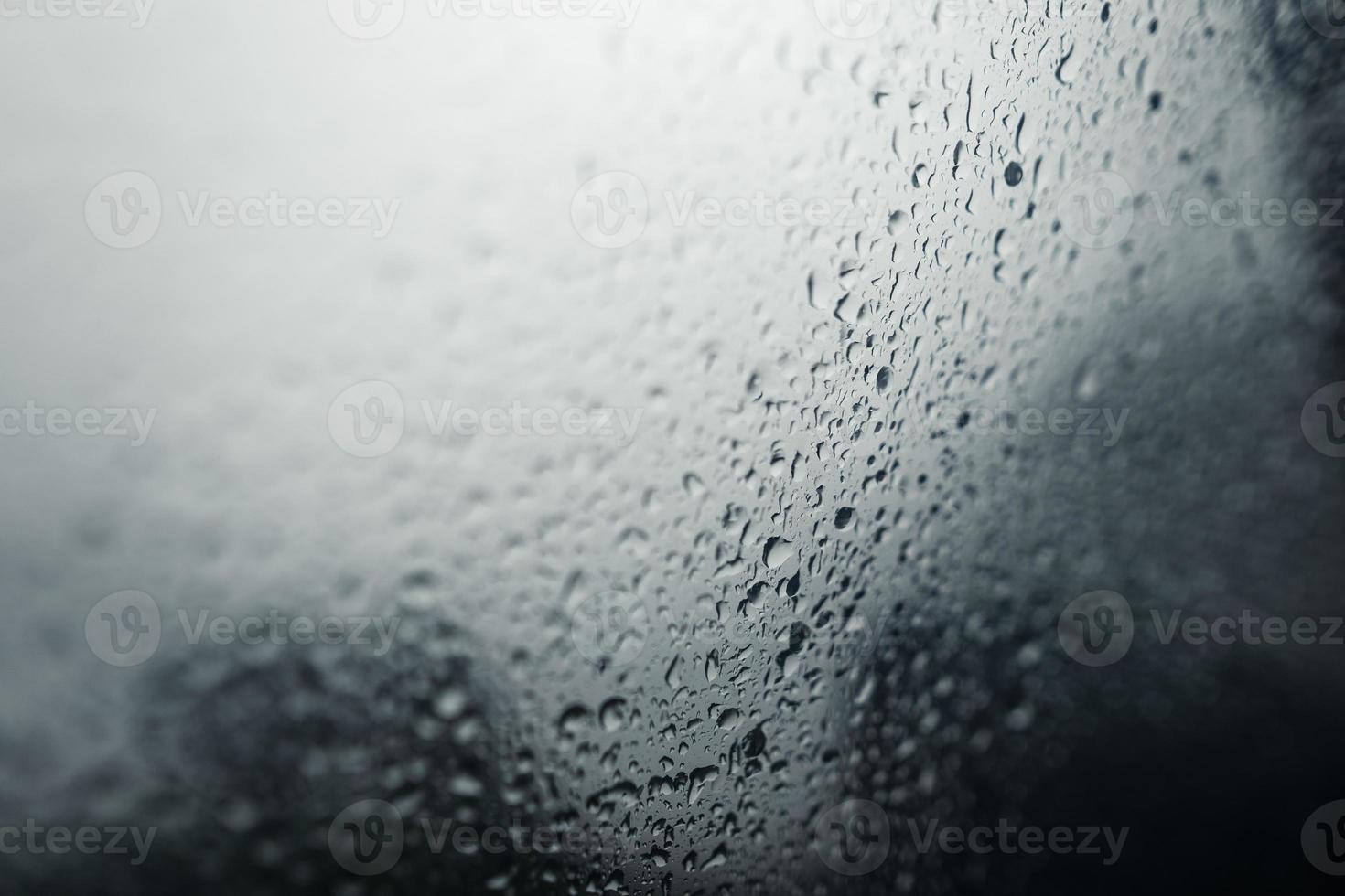 water droplets on car windshield on rainy day photo