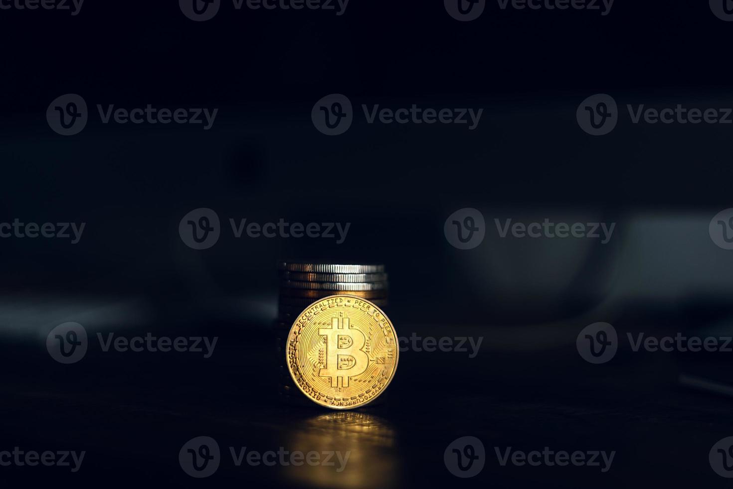 gold bitcoins placed on a wooden desk photo