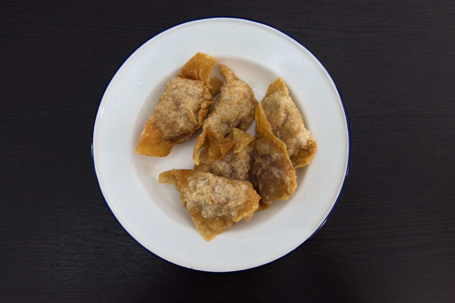 TOP VIEW .Deep fried wontons or dumpling on dish photo