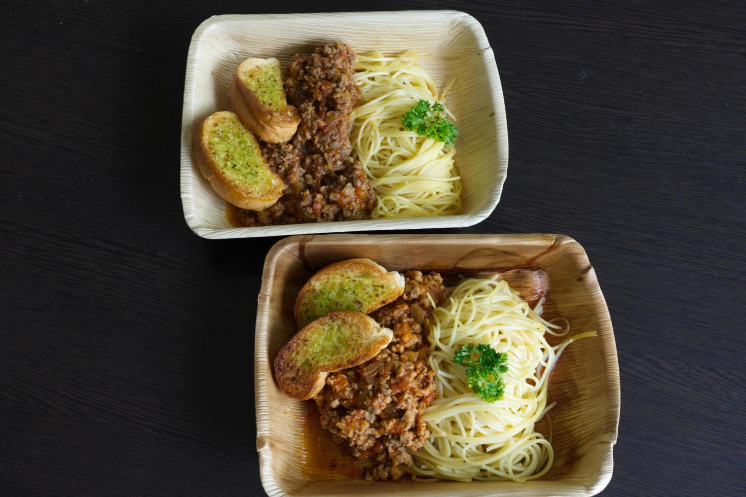 Spaghetti Pork Tomato Sauce with a slice of garlic baguette photo