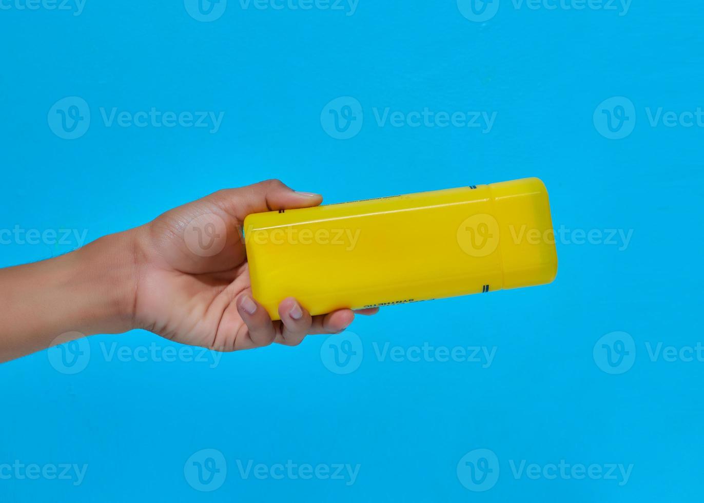 human hand that shows the movement will give box of yellow objects photo