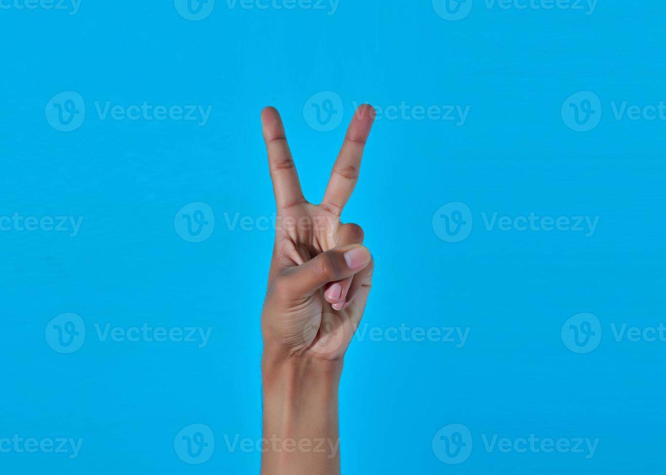 human hand showing victory, peace sign or number 2 with fingers. photo