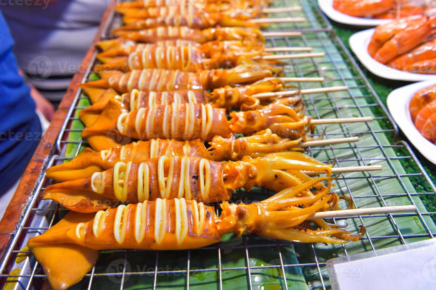 Grilled squid on stove in market photo