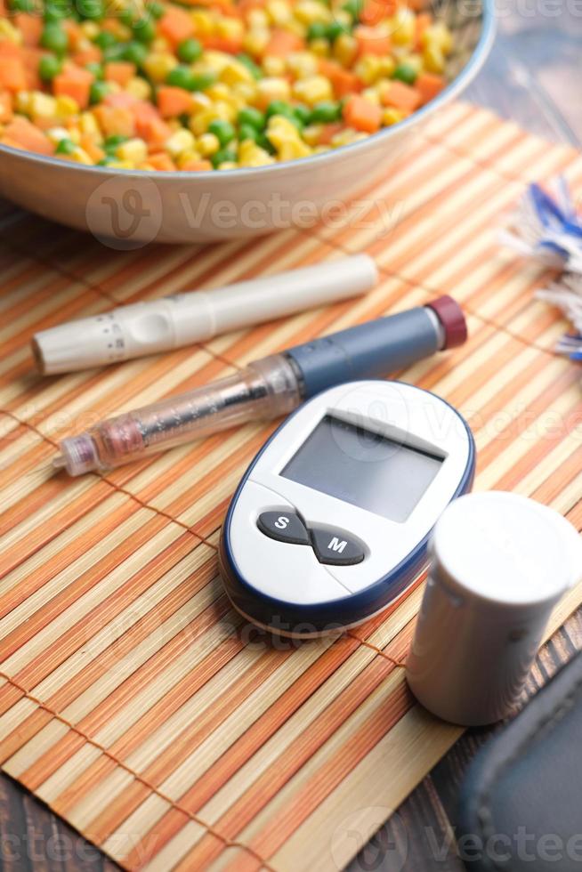 diabetic measurement tools and healthy food on table photo