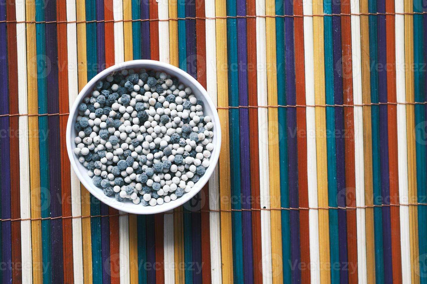 mixed pepper in a bowl on table , top view photo