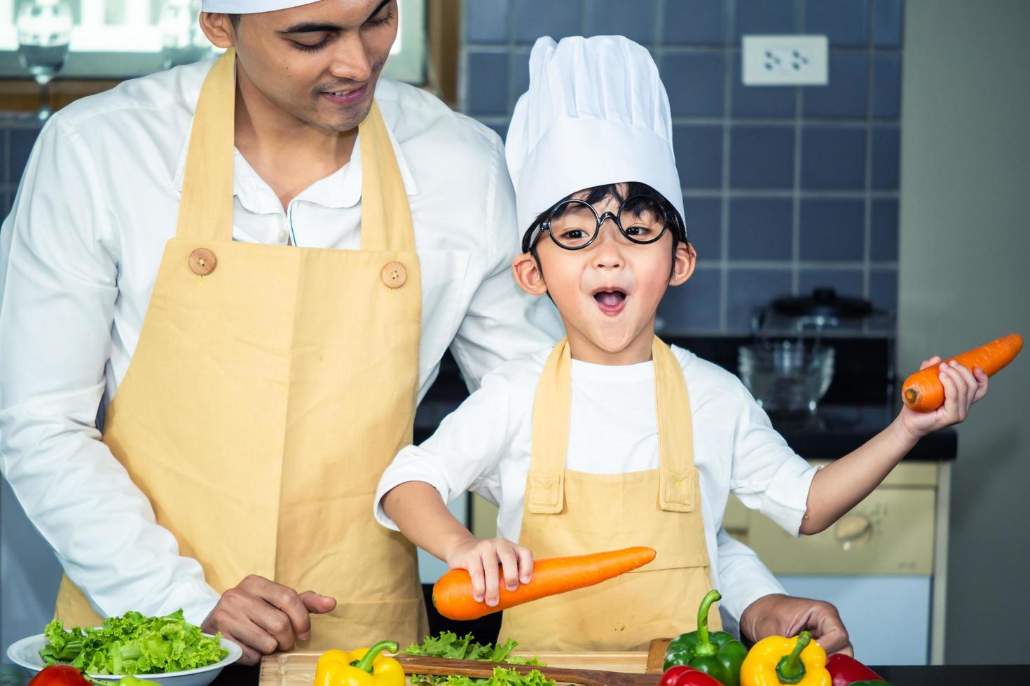 Asian woman young mother with son boy cooking salad photo
