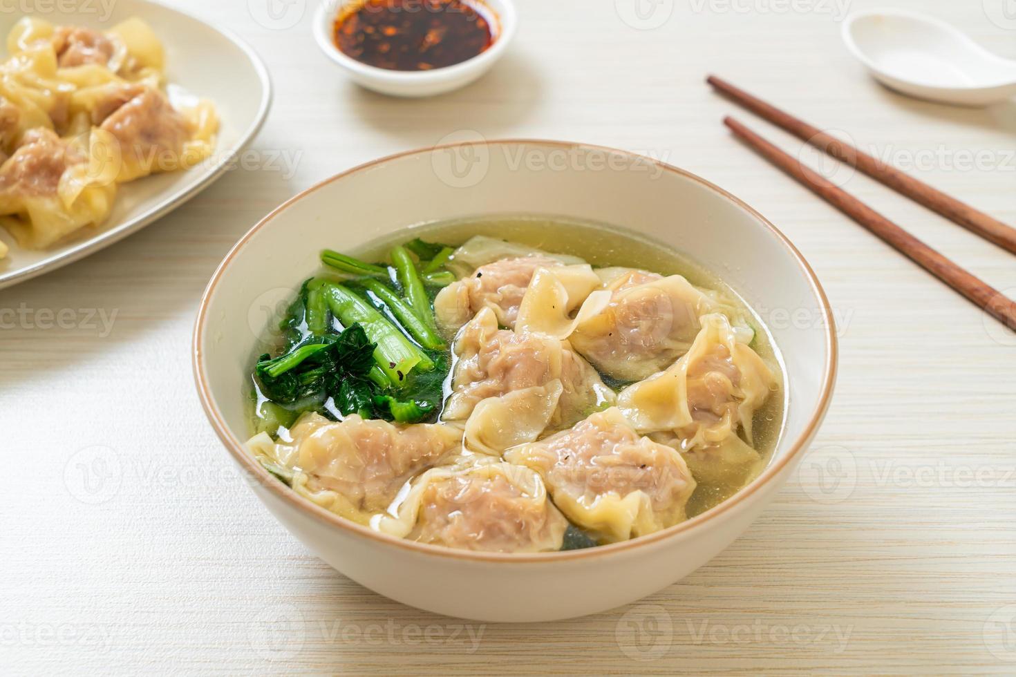 Pork wonton soup or pork dumplings soup with vegetable - Asian food style photo