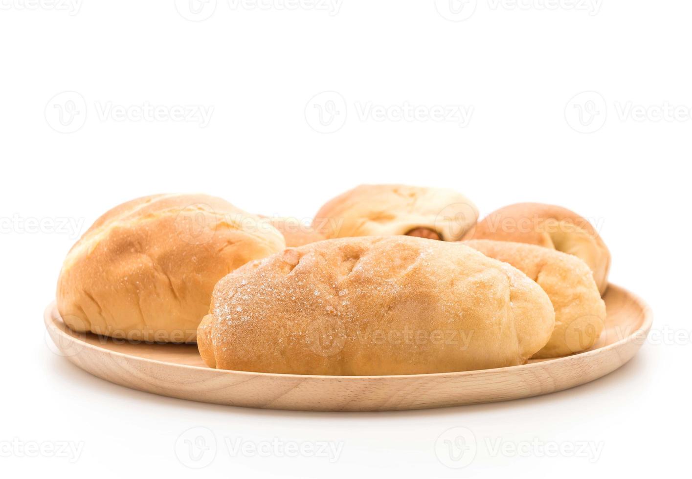 Bread in wood plate on white background photo