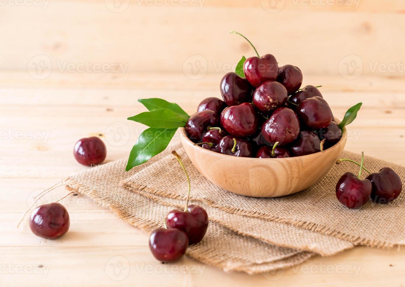 Fresh cherry in wood bowl on the table photo