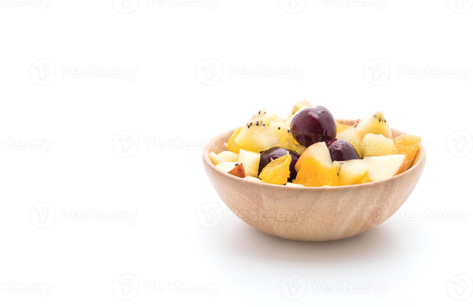 Mixed sliced fruit in wood plate photo