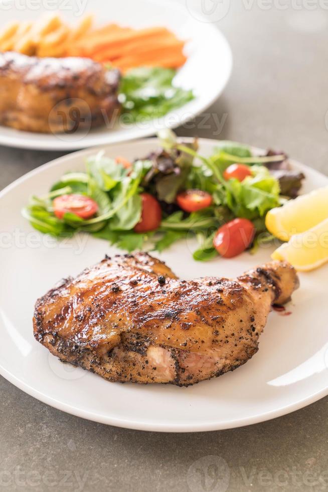 Thigh chicken steak on dining table photo