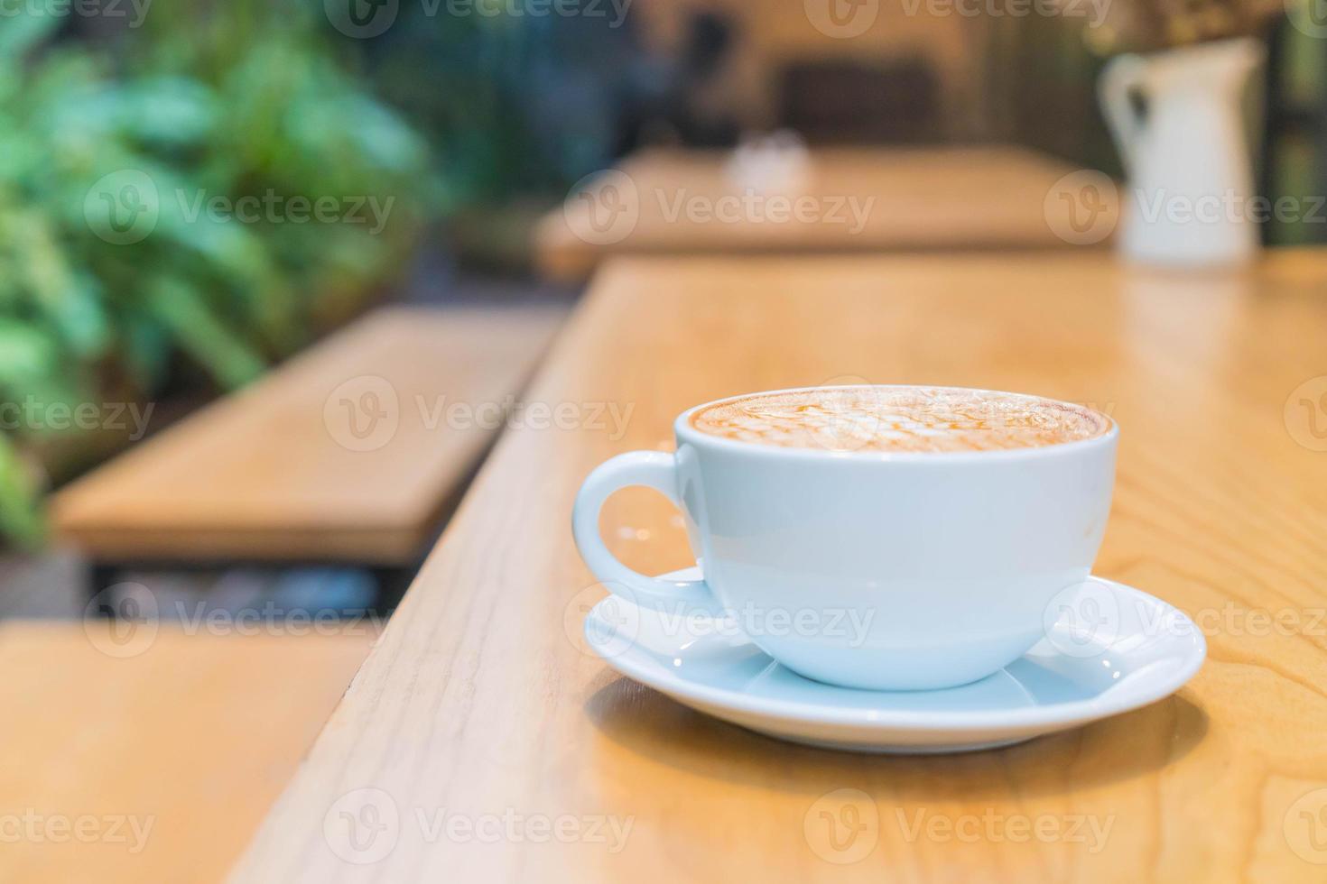 Hot caramel macchiato in coffee shop photo