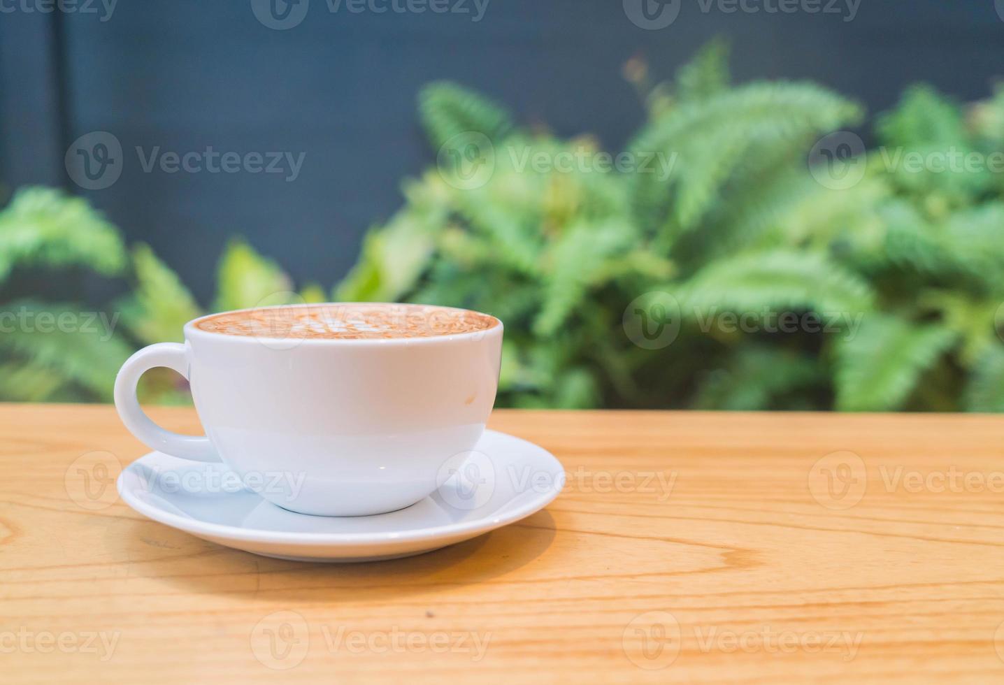 Hot caramel macchiato in coffee shop photo