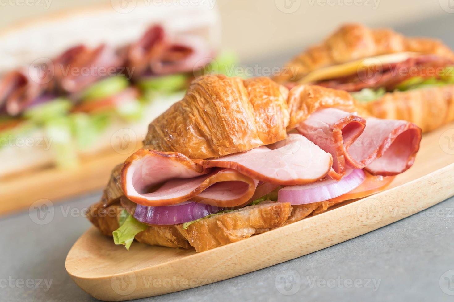 Jamón sándwich croissant en la mesa foto