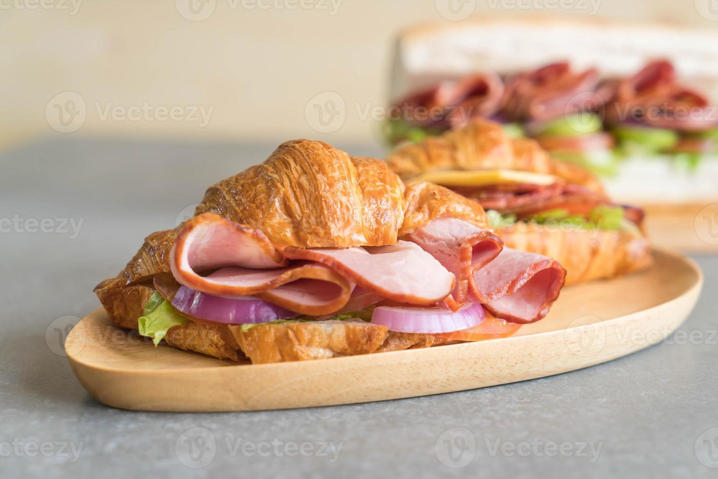 Croissant sandwich ham on table photo