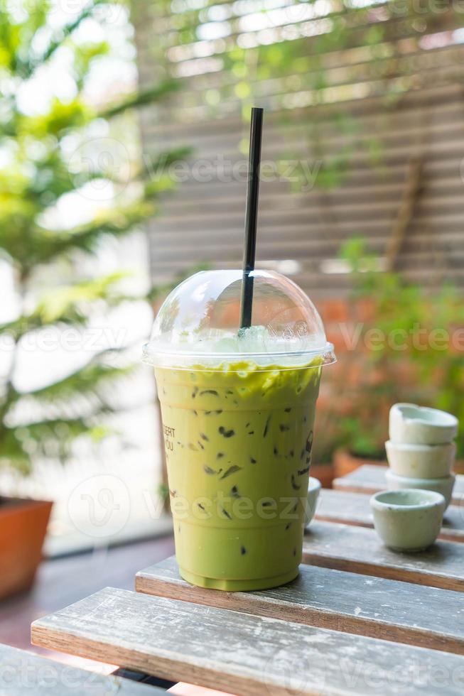 Iced green tea milkshake on table photo