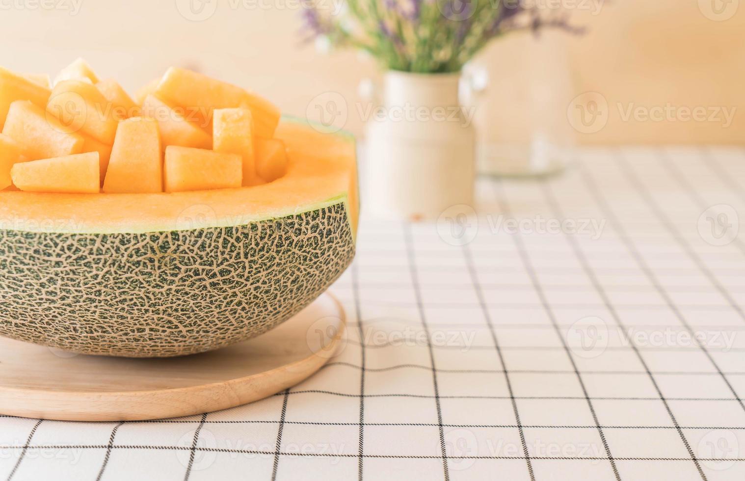 Fresh cantaloupe melon for dessert on table photo