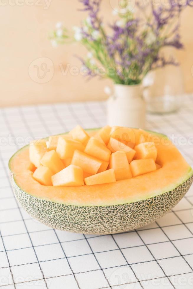 Fresh cantaloupe melon for dessert on table photo