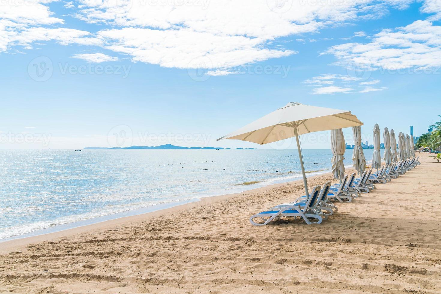 Outdoor with umbrella and chair on beautiful tropical beach and sea photo