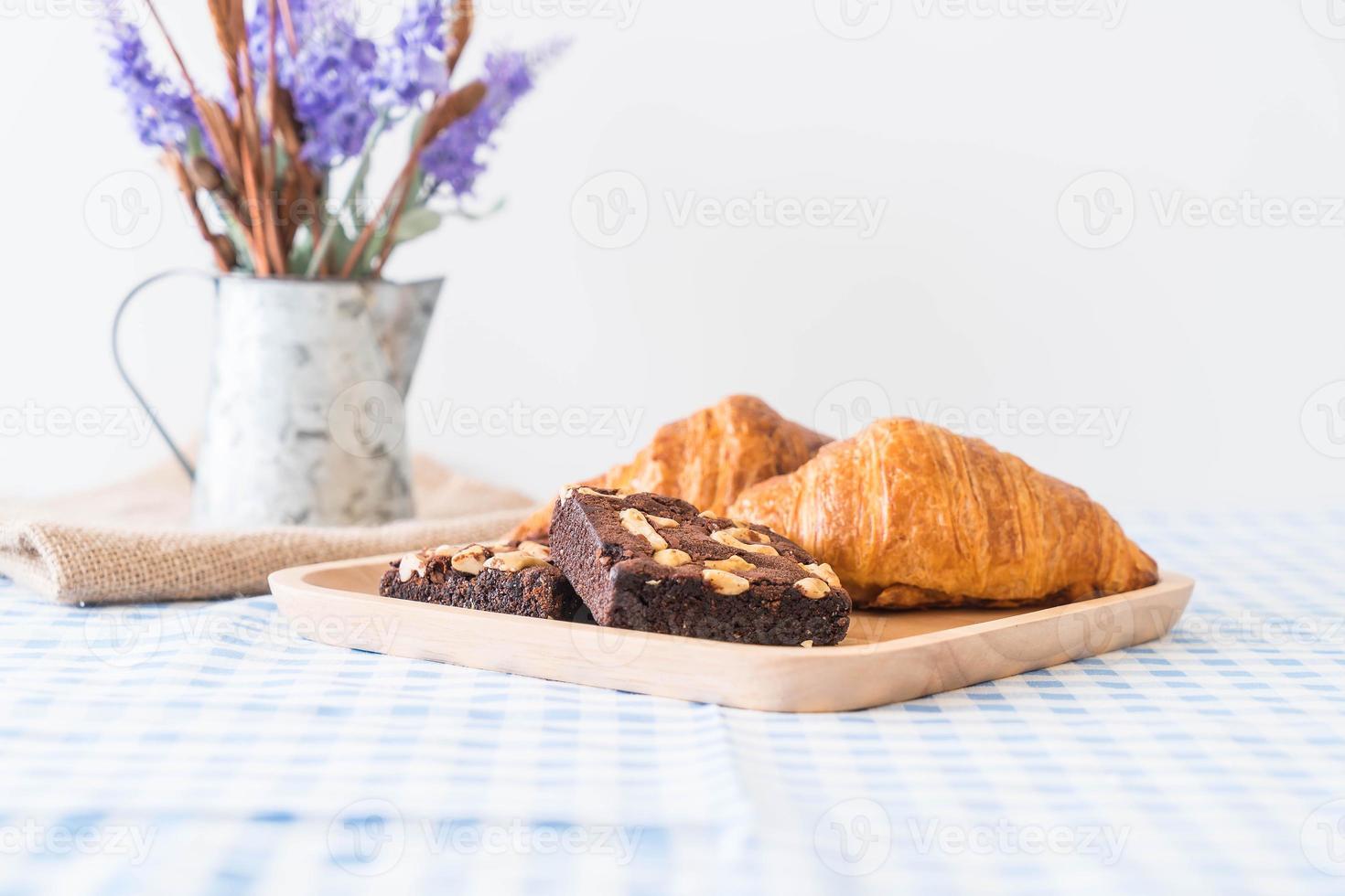 Croissant and brownies on table photo