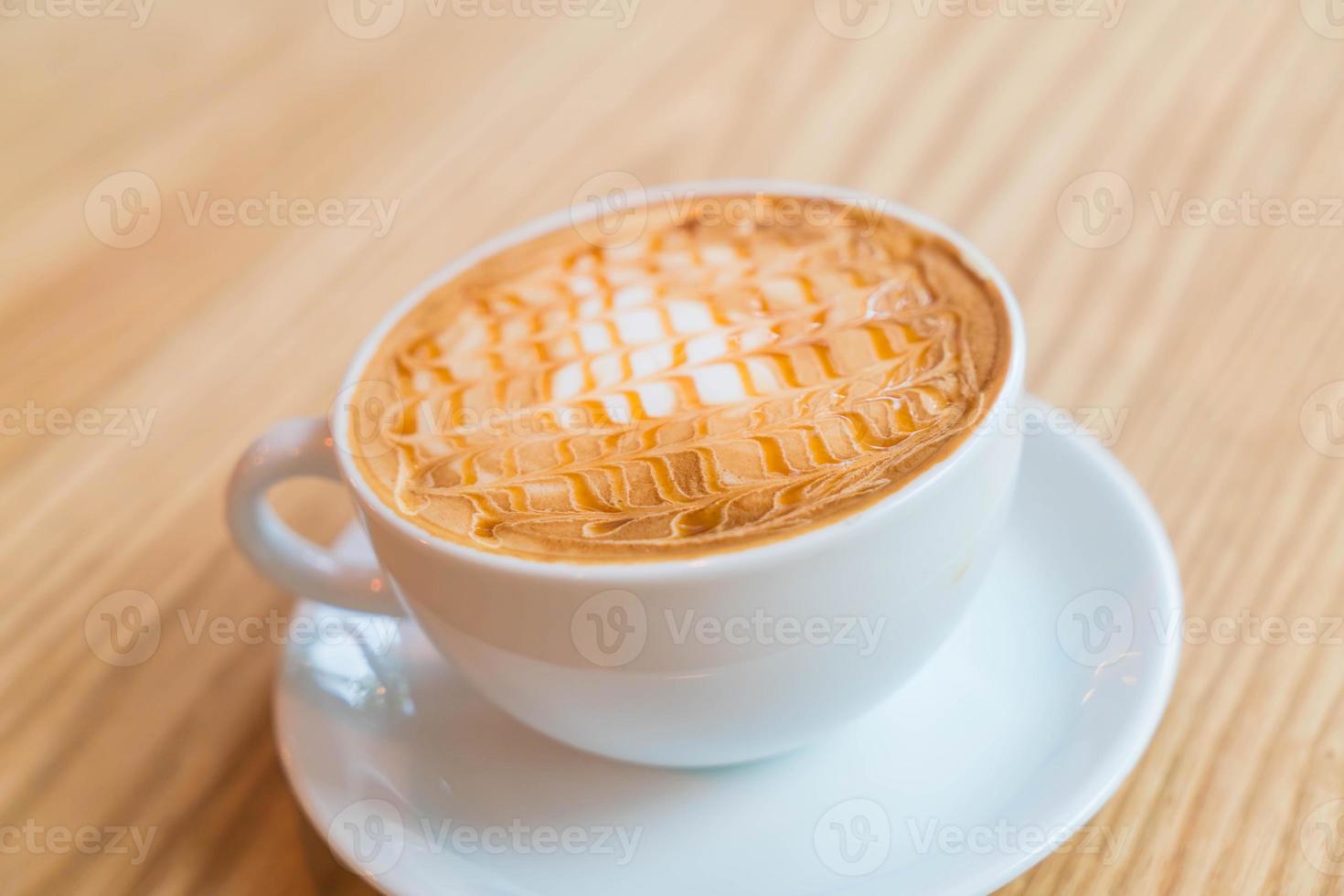 Hot caramel macchiato in coffee shop photo