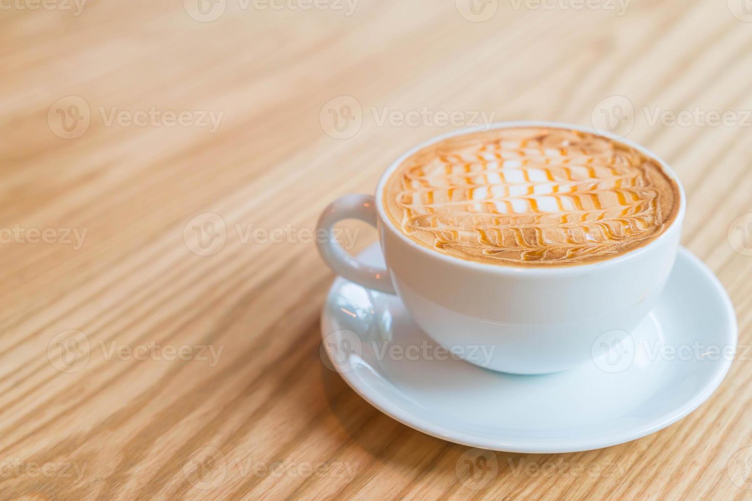 Hot caramel macchiato in coffee shop photo