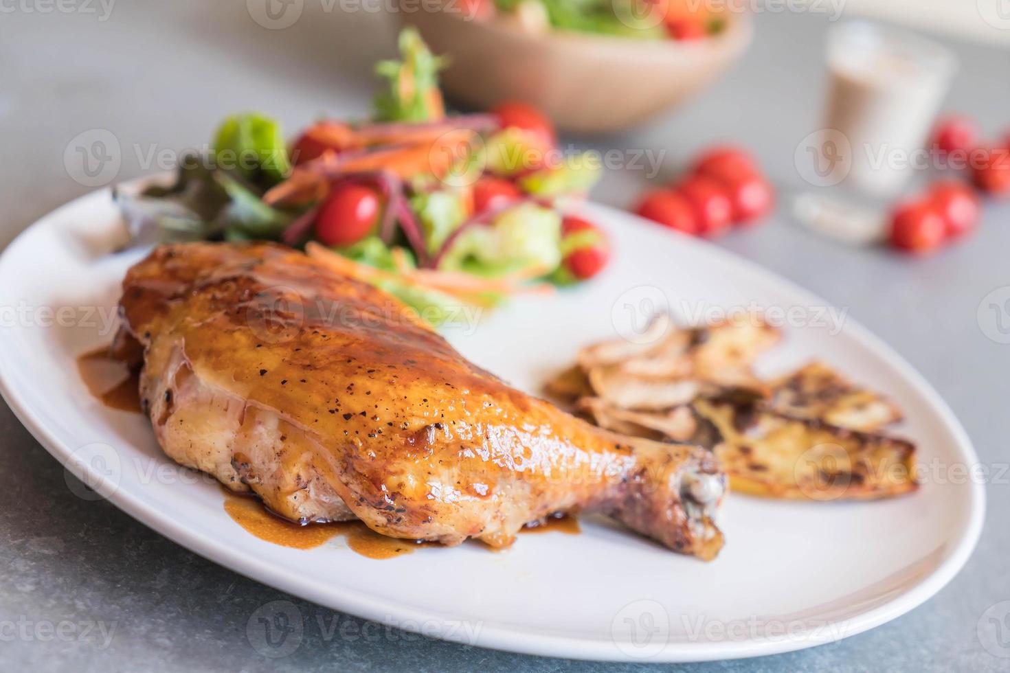 Grilled chicken steak with teriyaki sauce on dining table photo