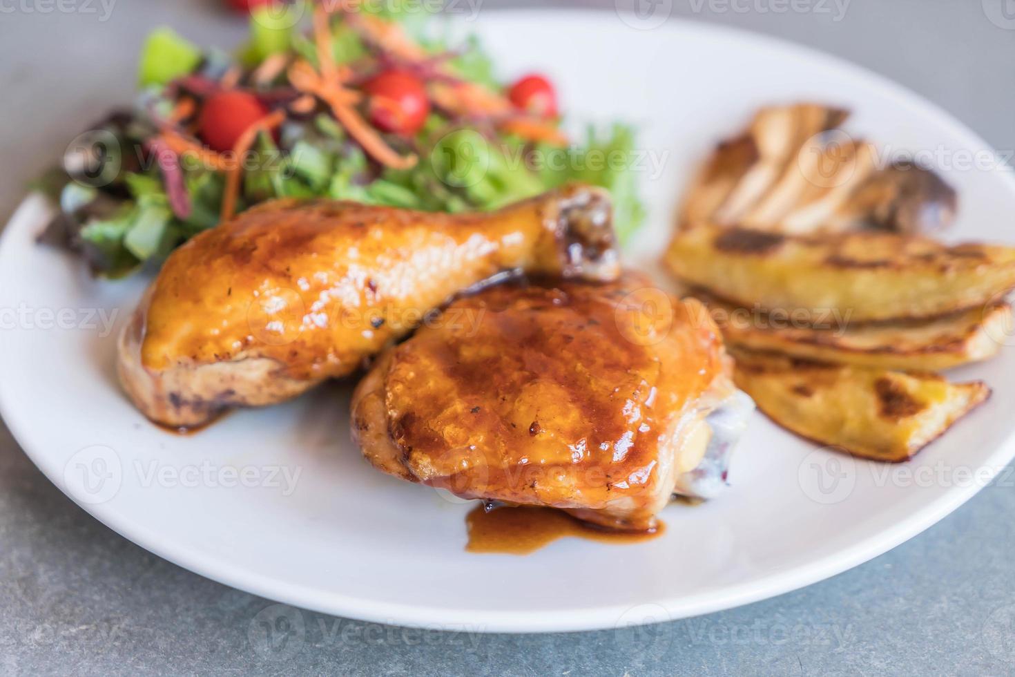 Grilled chicken steak with teriyaki sauce on dining table photo