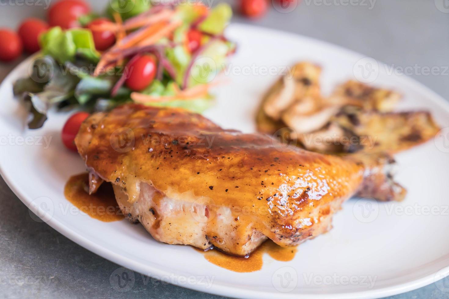 Grilled chicken steak with teriyaki sauce on dining table photo