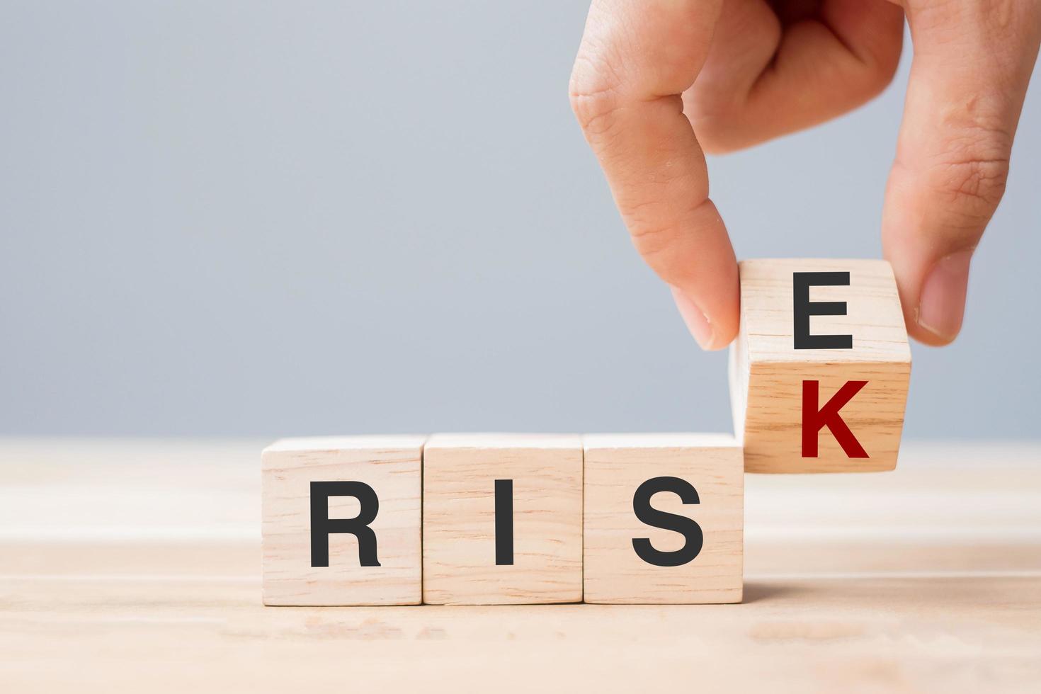 Flipping wooden blocks with RISK change to RISE photo