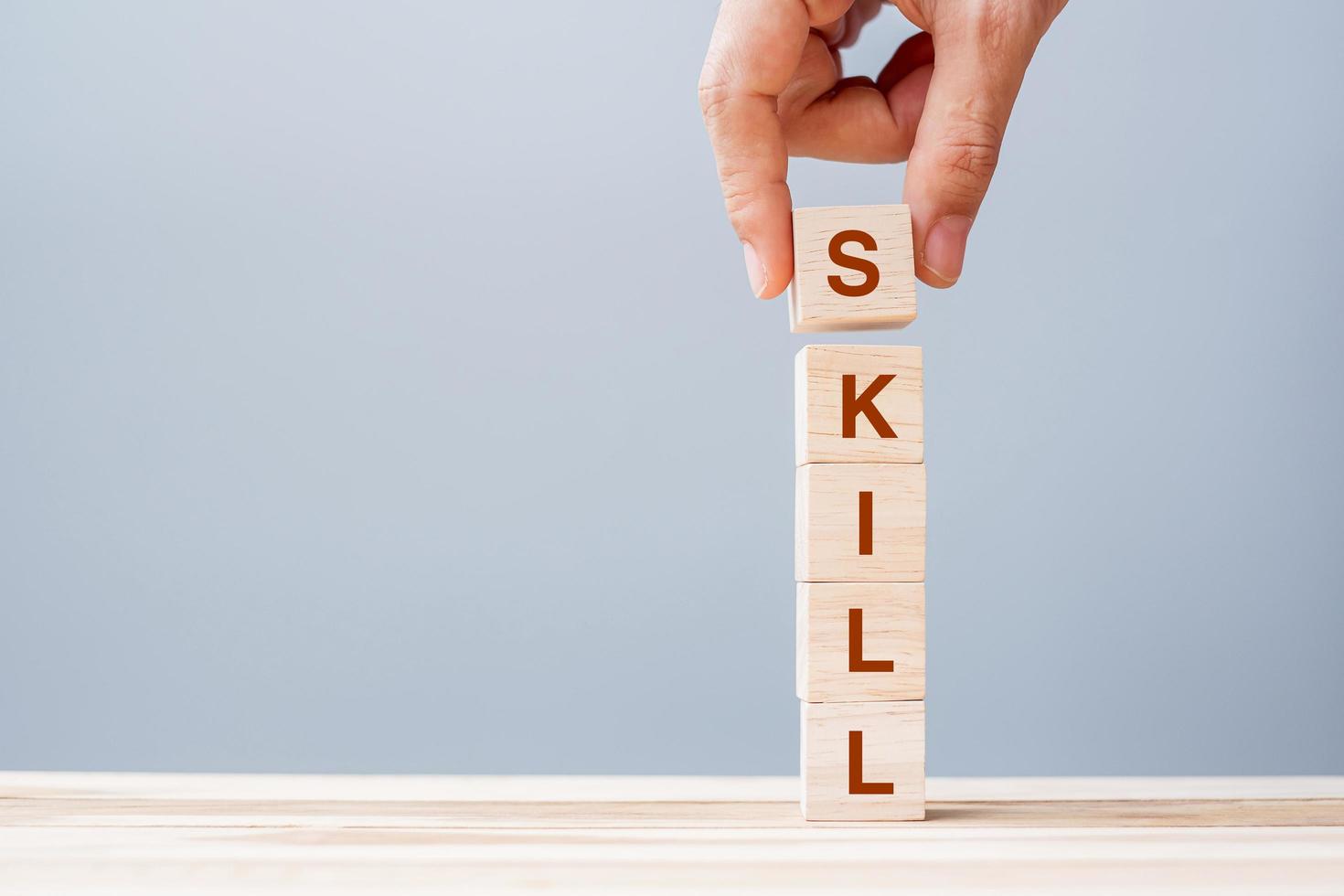 Hand holding wooden block with SKILL word photo