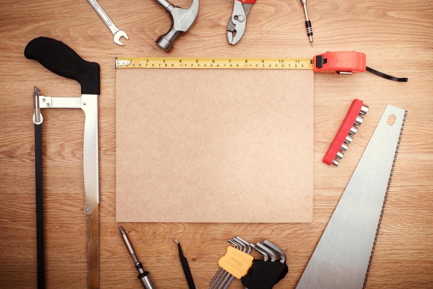 Working tools on wooden background. top view photo