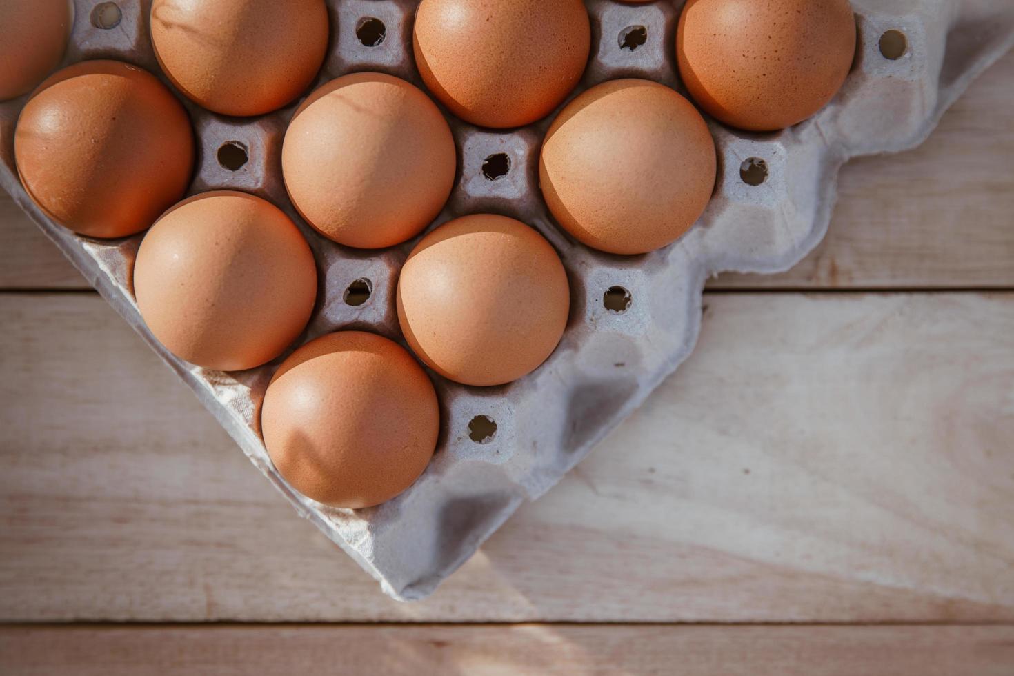 Eggs in paper boxes placed on wooden floors photo