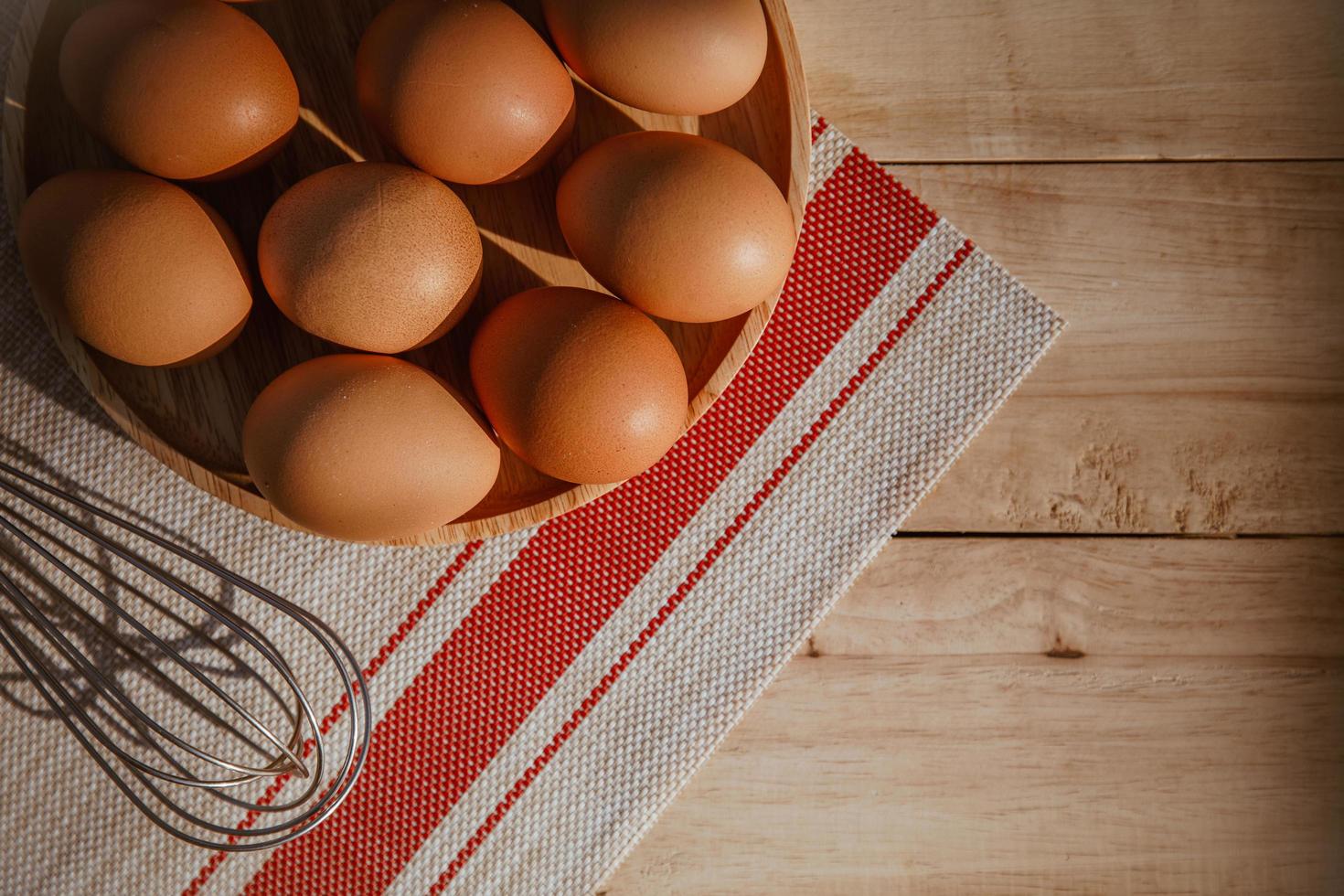 eggs in a wooden bowl. close up, top view, horizontal photo