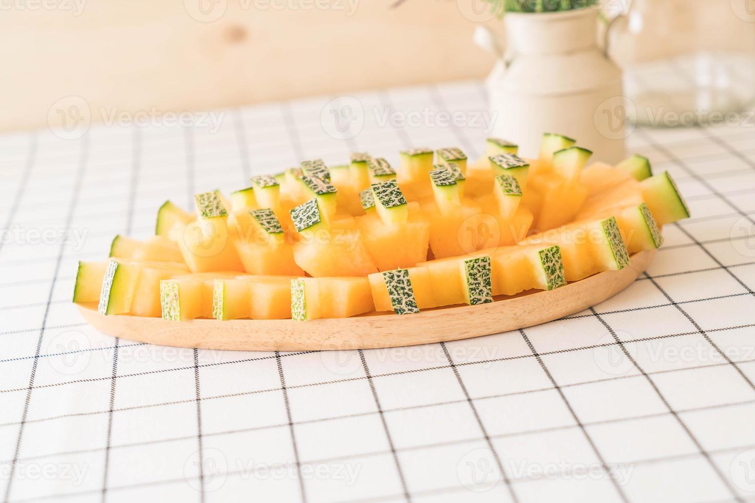 Fresh cantaloupe melon for dessert on table photo