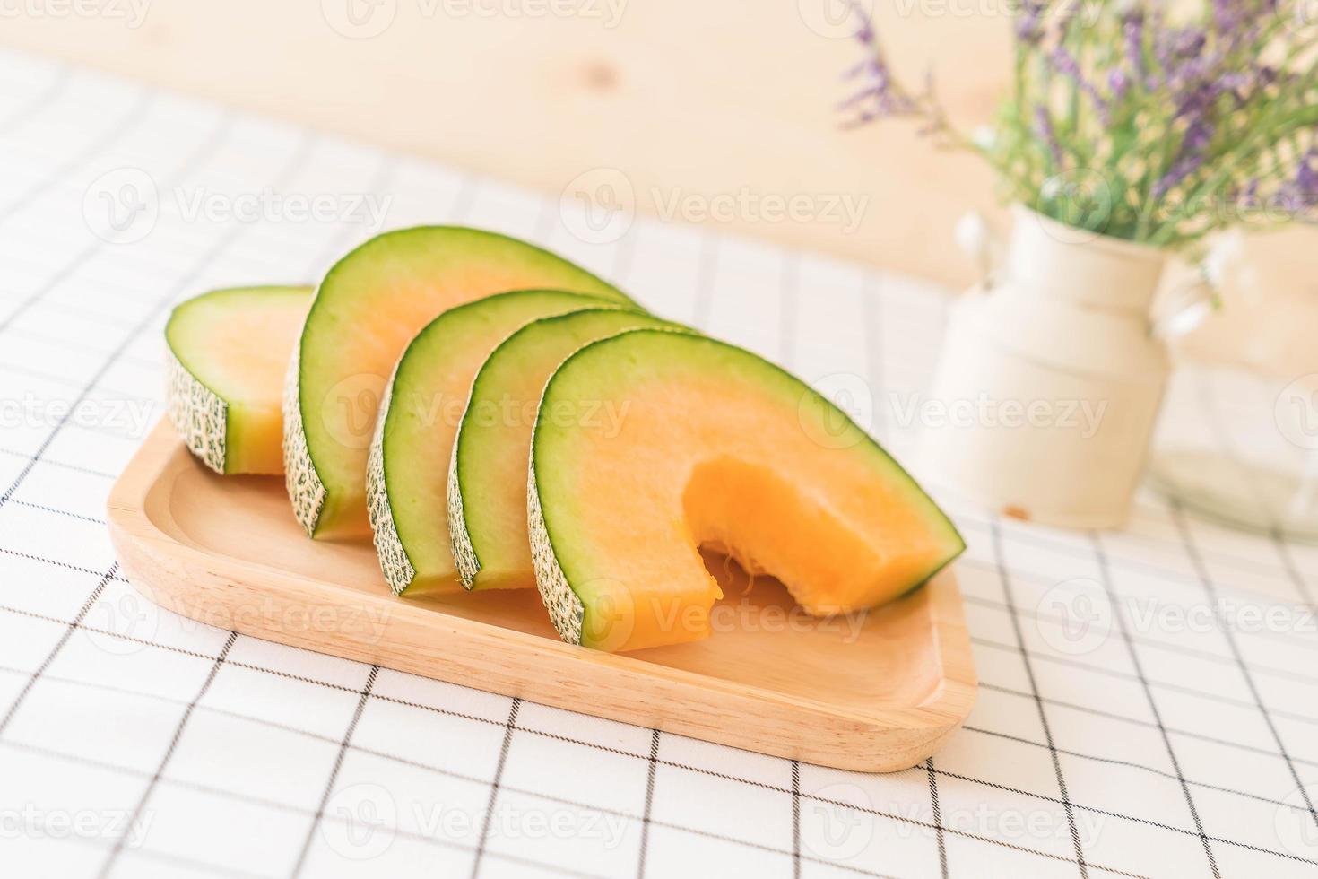 Fresh cantaloupe melon for dessert on table photo