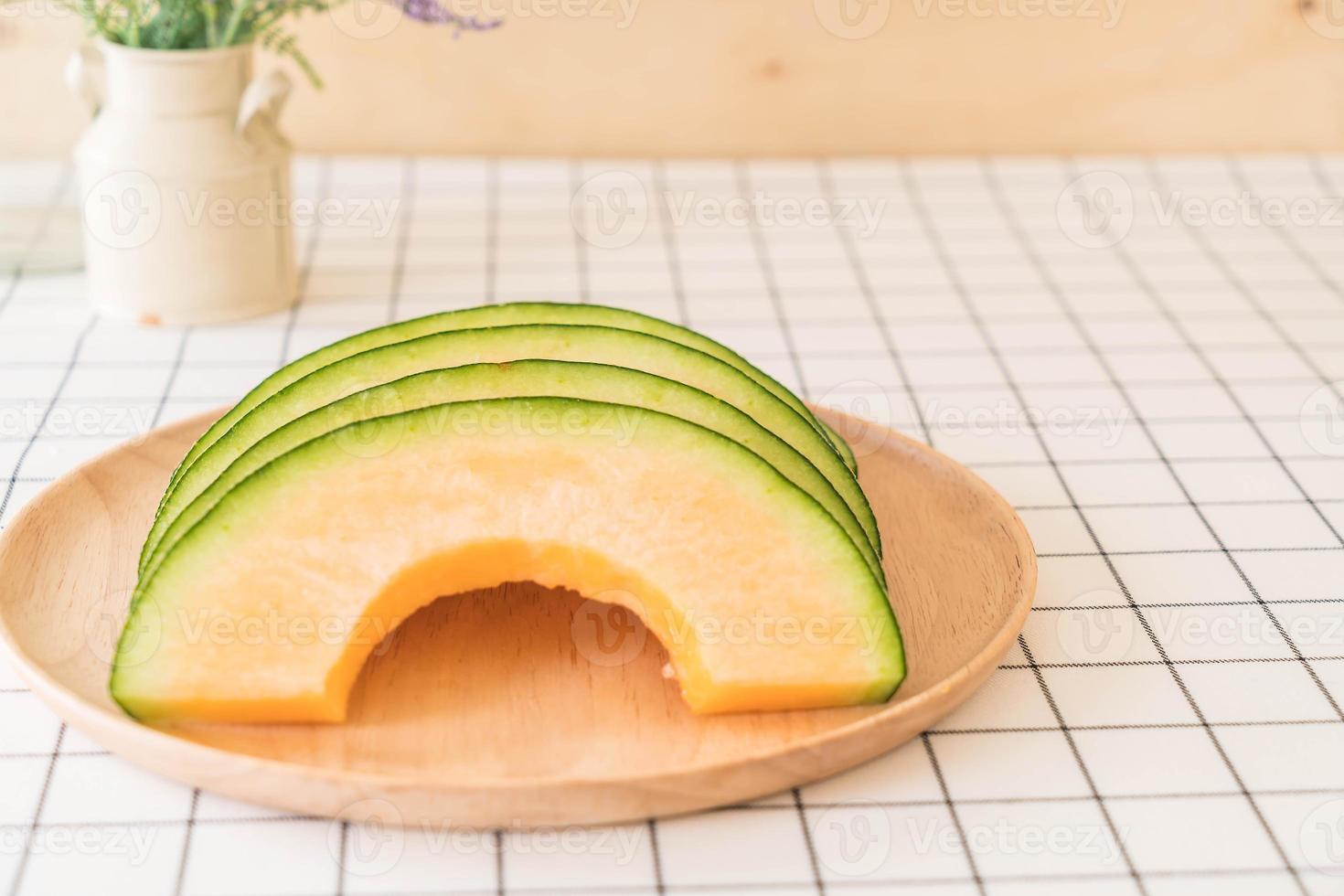 Fresh cantaloupe melon for dessert on table photo