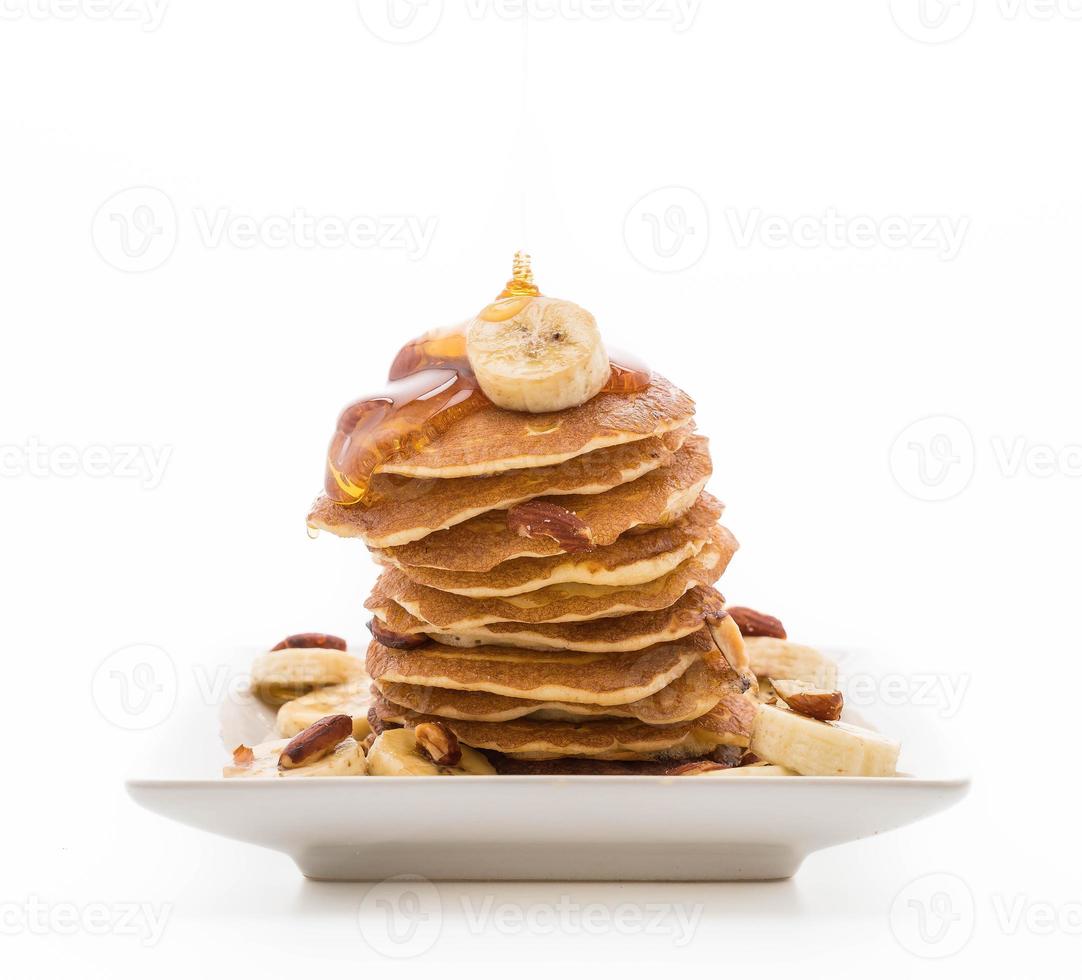 Almond banana pancake with honey on white background photo