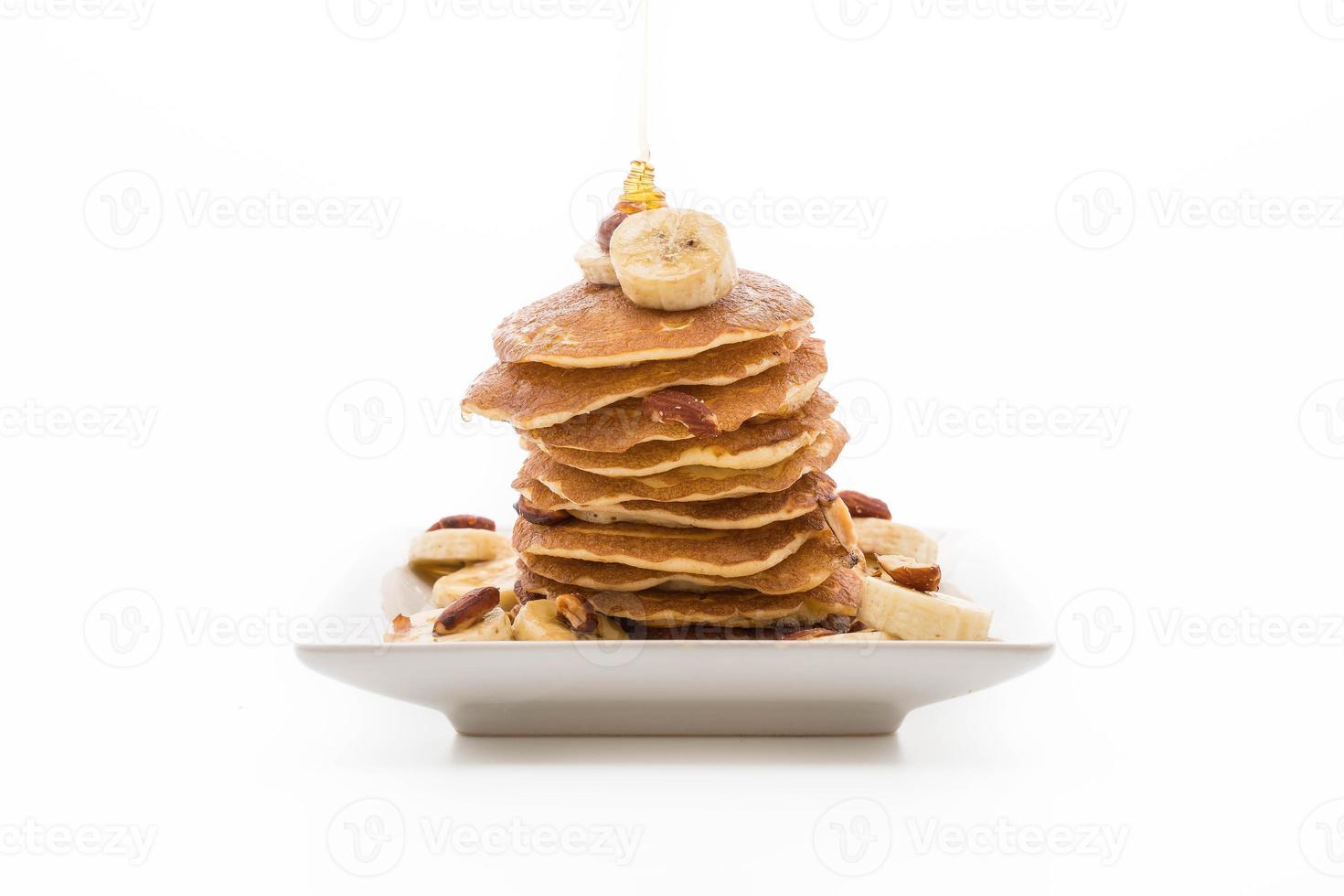 Almond banana pancake with honey on white background photo