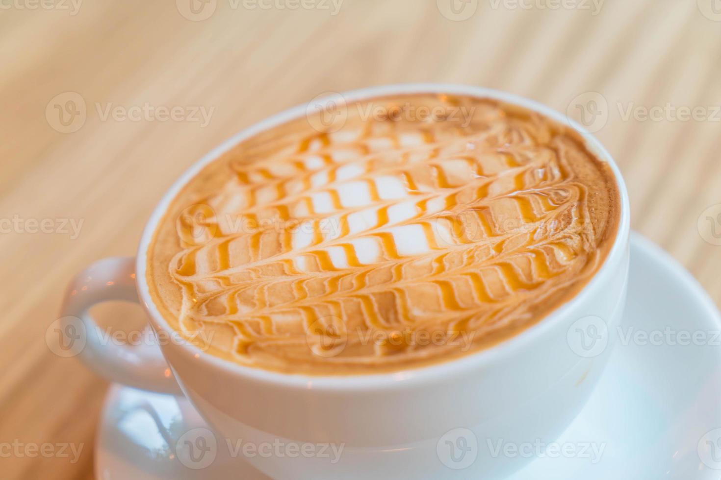 Hot caramel macchiato in coffee shop photo