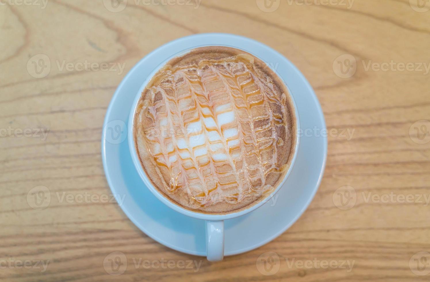 Hot caramel macchiato in coffee shop photo