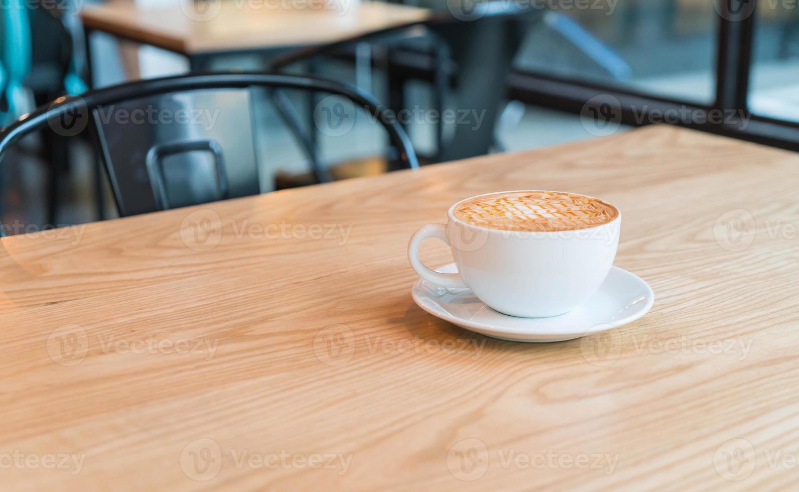 Hot caramel macchiato in coffee shop photo