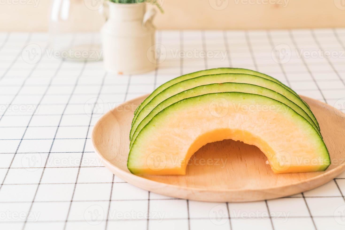 Fresh cantaloupe melon for dessert on table photo