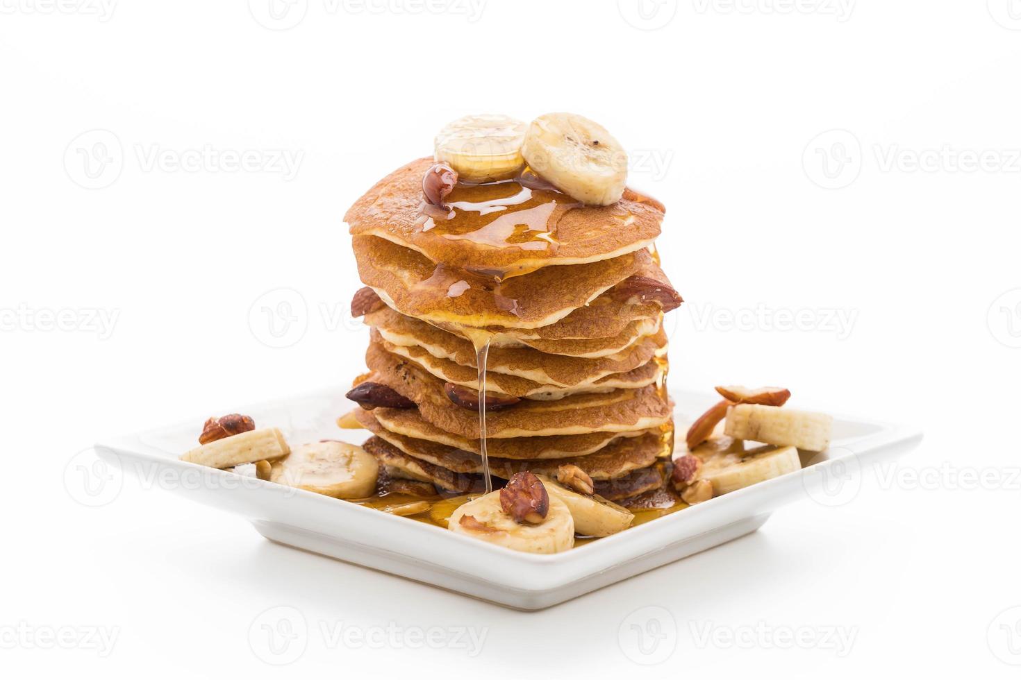 Almond banana pancake with honey on white background photo