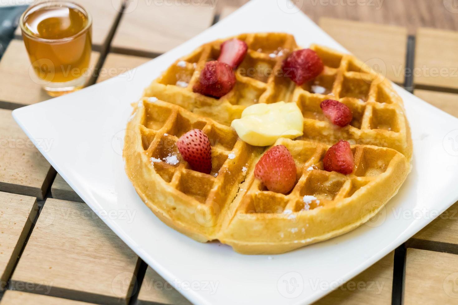 Butter waffle with honey and strawberry - dessert photo