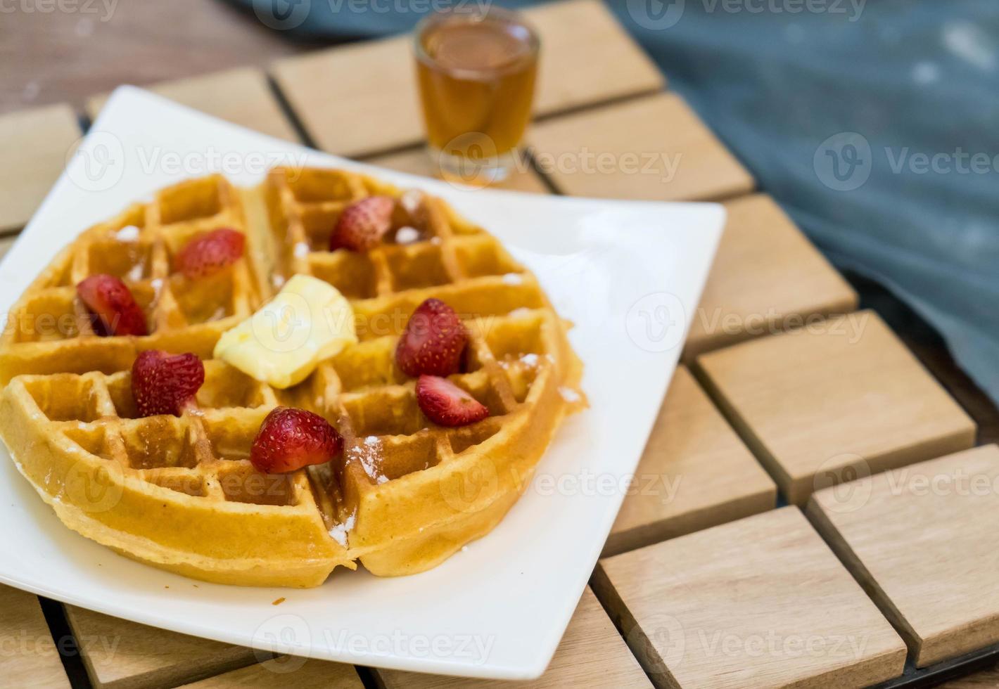 Butter waffle with honey and strawberry - dessert photo