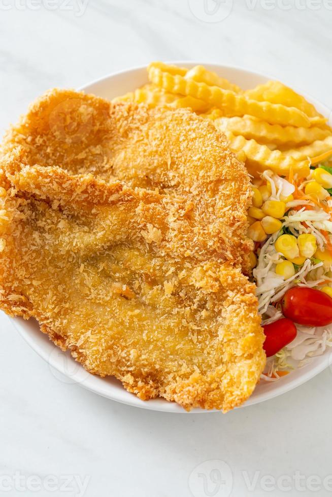 Fish and chips with mini salad on white plate photo