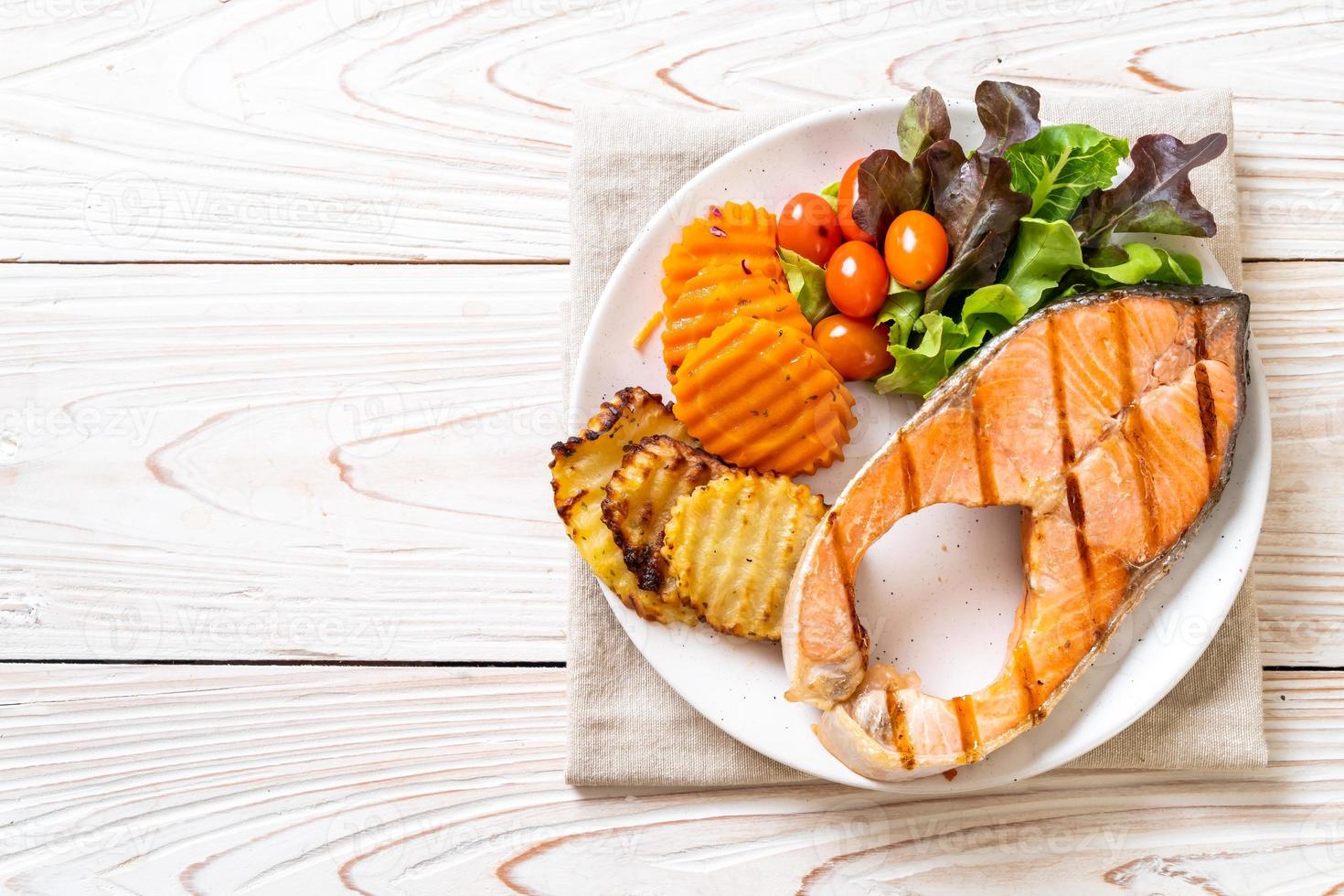 Filete de salmón a la plancha con verduras en la placa foto