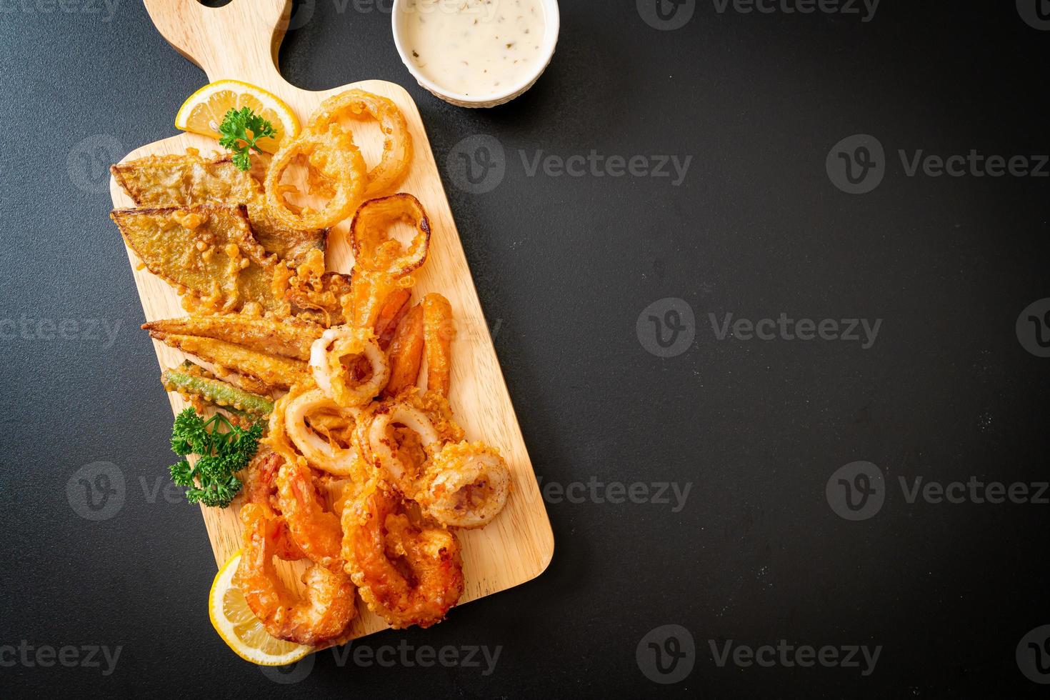 Deep-fried seafood of shrimp and squid with mix vegetables - unhealthy food style photo