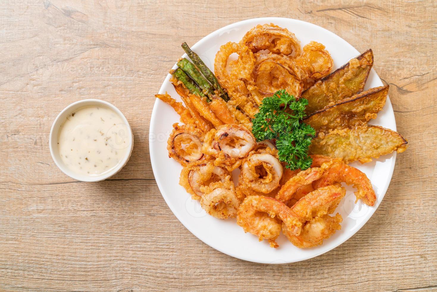 Deep-fried seafood of shrimp and squid with mix vegetables - unhealthy food style photo